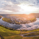 View over Piesport on the Mosel River, with the steep Piesporter Goldtröpfchen vineyards rising around the village.